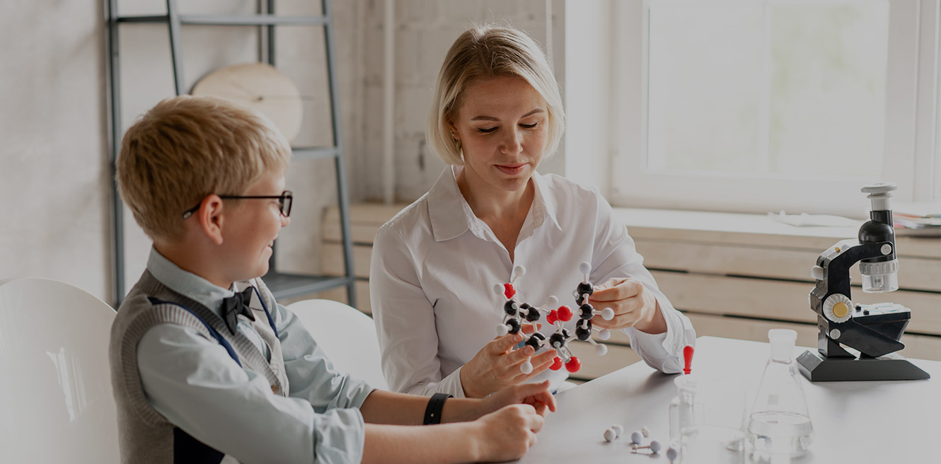 Female science tutor in Tacoma studying chemistry with student